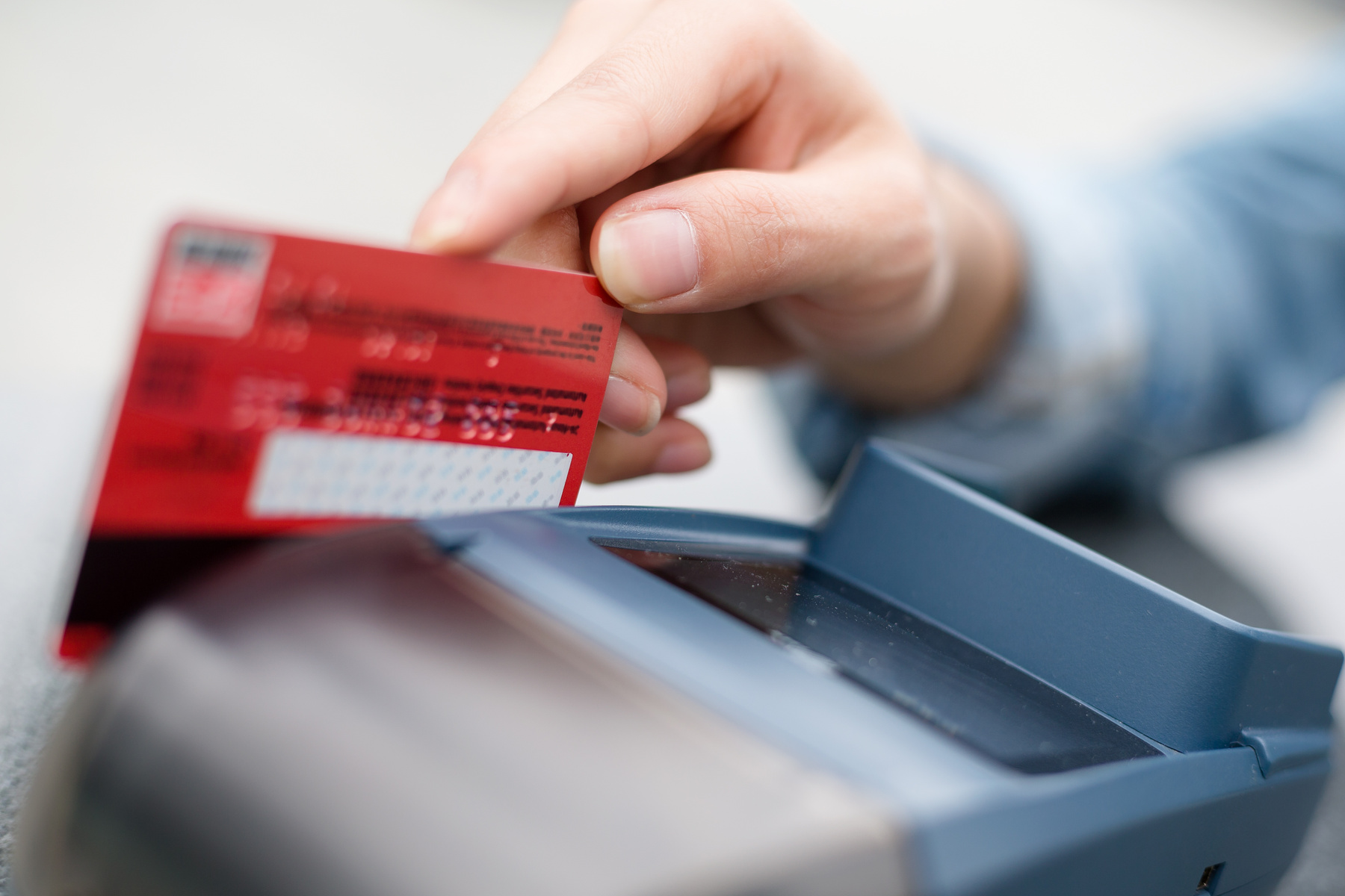 mp21959497-hand-swiping-credit-card-in-store